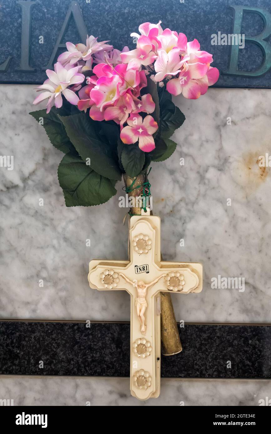 Cross and artifical flowers on a grave in Amalfi Cemetery, Amalfi Town, Salerno, Campania, Italy Stock Photo