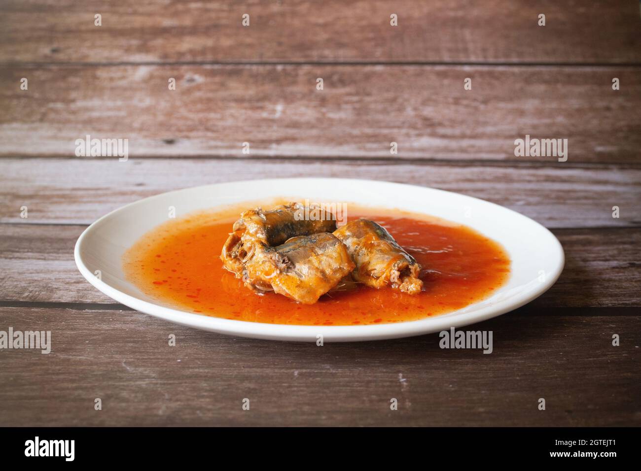 Canned Fish In Tomato Sauce On Wood Background, Sardines, Mackerel