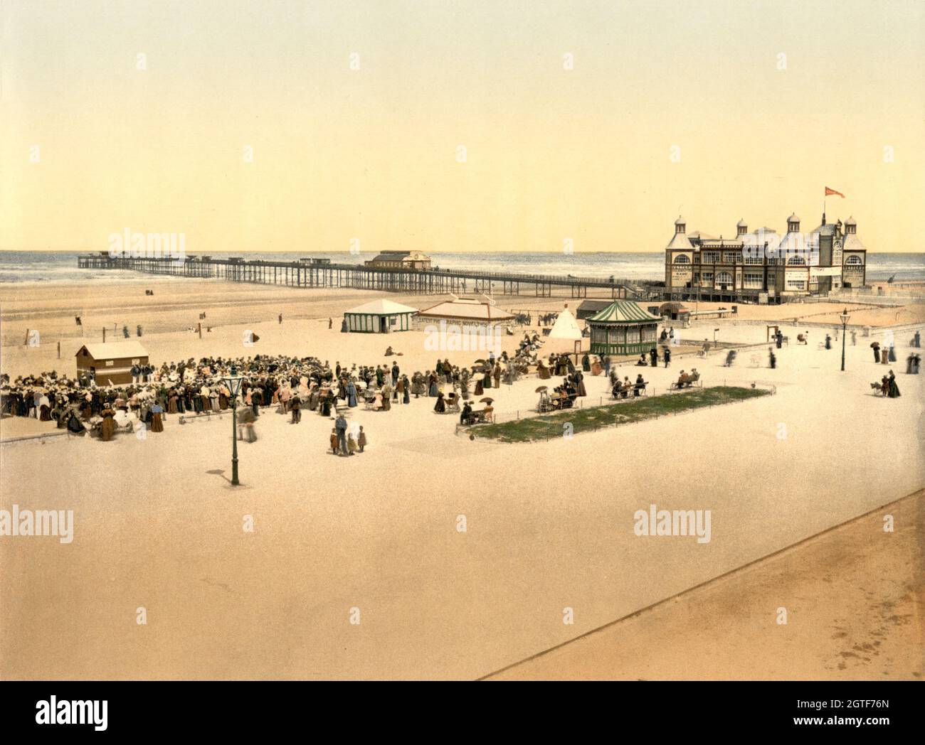 Vintage colour photo circa 1900 of the original Rhyl Victoria Pier and Grand Pavilion on the North Wales coast. The pleasure pier was opened was in August 1867 and was the first pier in North Wales.   The Grand Pavilion was opened in 1891.  The pier was demolished in March 1973 Stock Photo