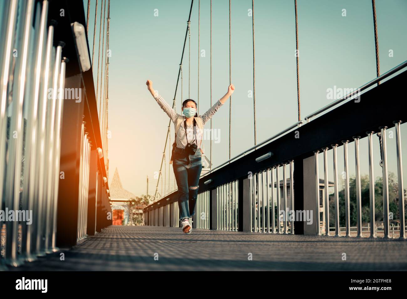 Man Standing On Bridge Against Sky During Sunset Stock Photo