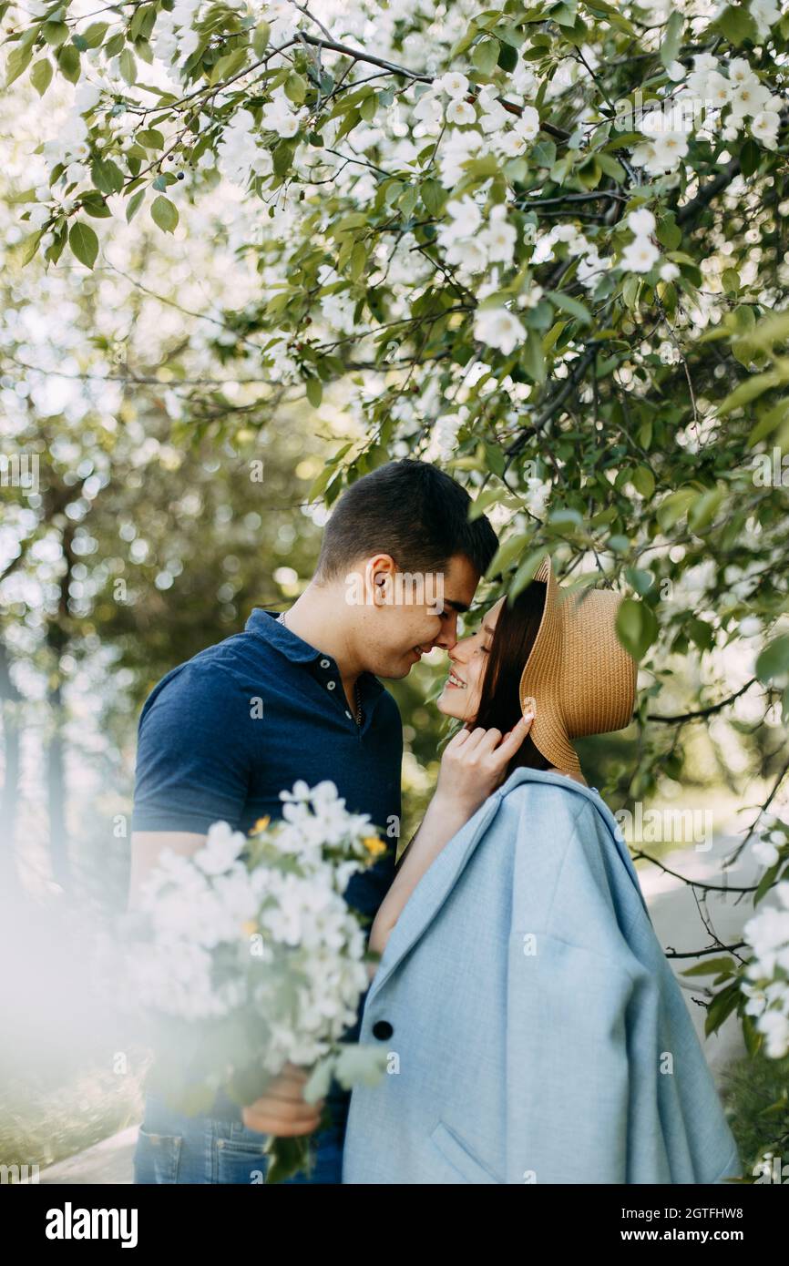 Couple kissing at blooming tree hi-res stock photography and images - Alamy