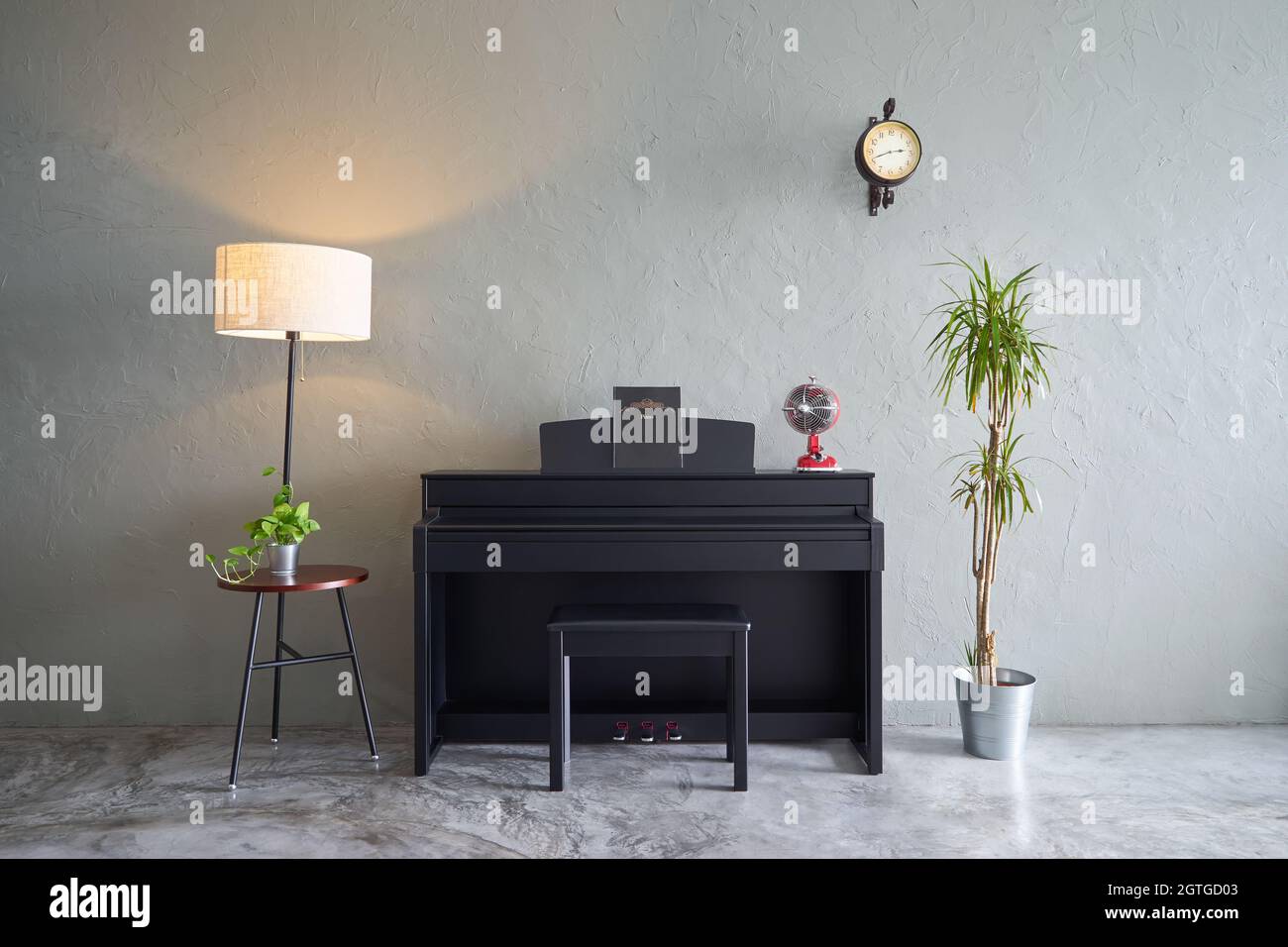 Piano With Decor Against Wall Stock Photo - Alamy