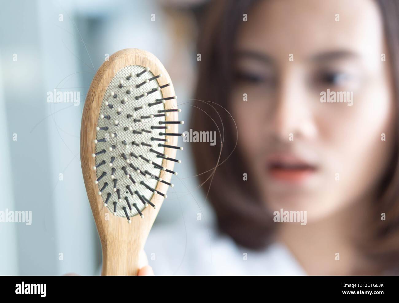 Woman Showing Comb With Hair Stock Photo