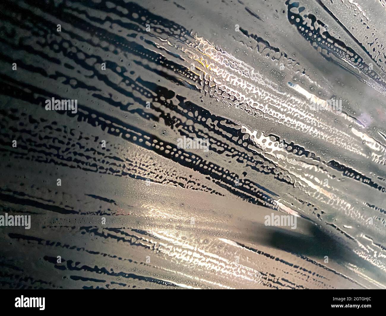 View through the window of a vehicle going through an automated car wash. Stock Photo