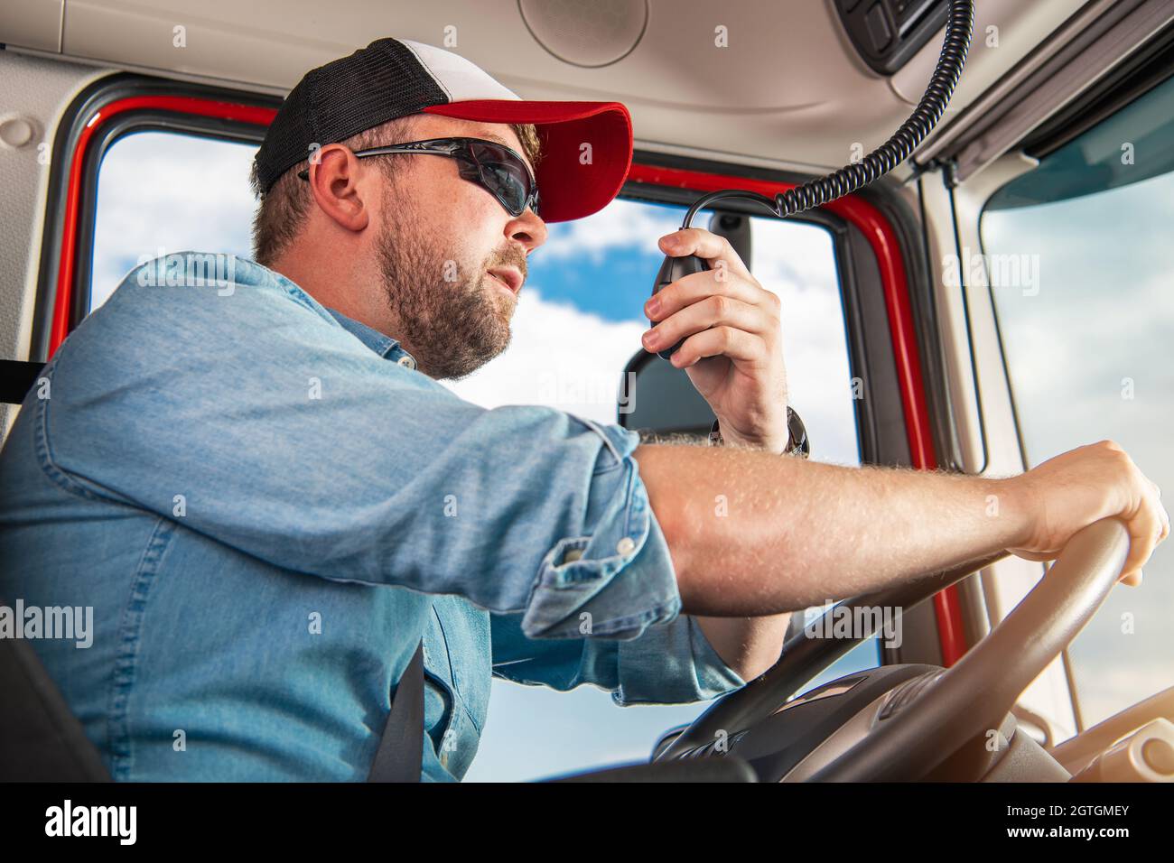 Caucasian Semi Truck Driver In His 30s Taking Conversation Using Cb