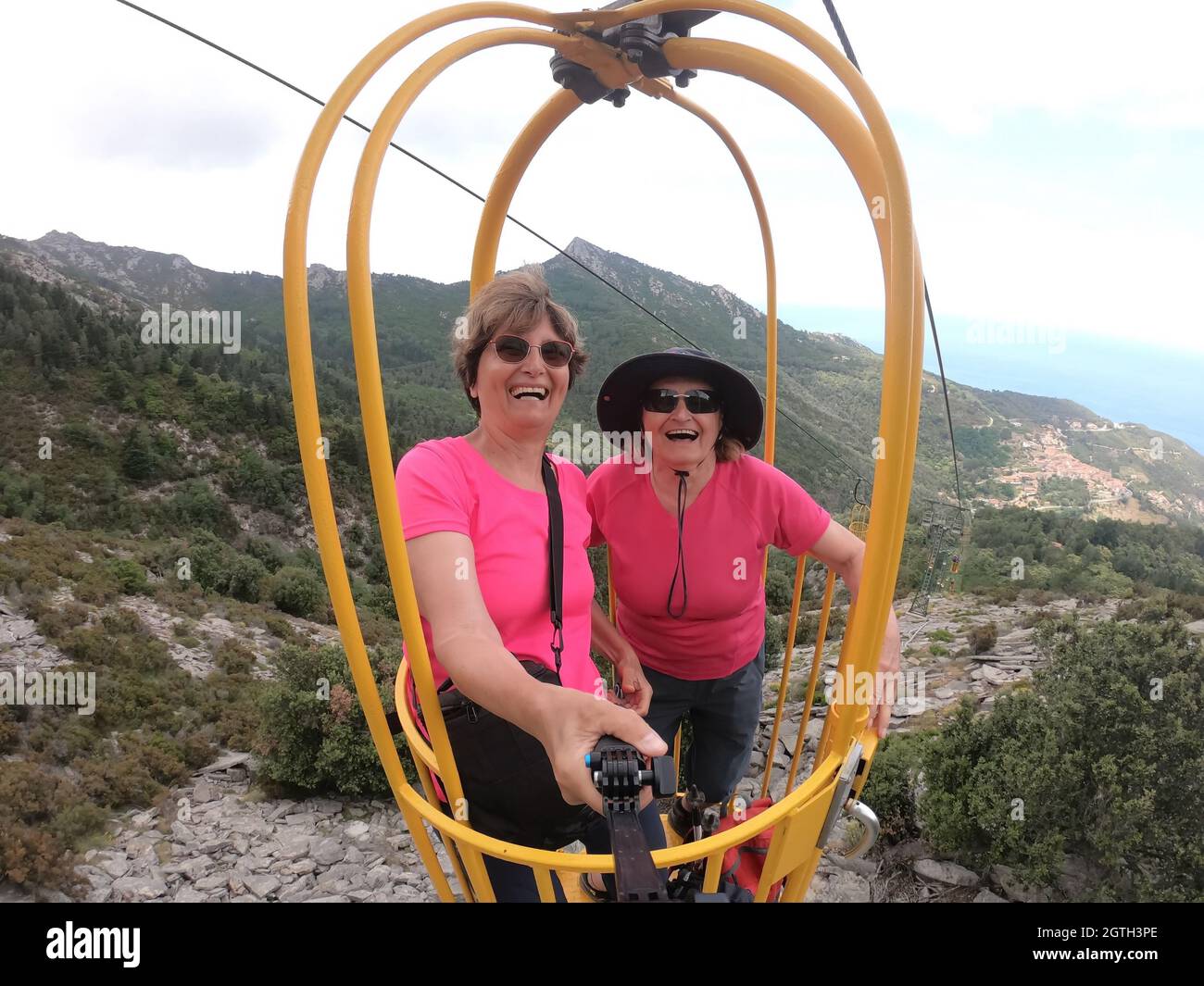 Senior Women Enjoying Cable Car Ride In Yellow Basket From The Top Of Elba  Island Stock Photo - Alamy