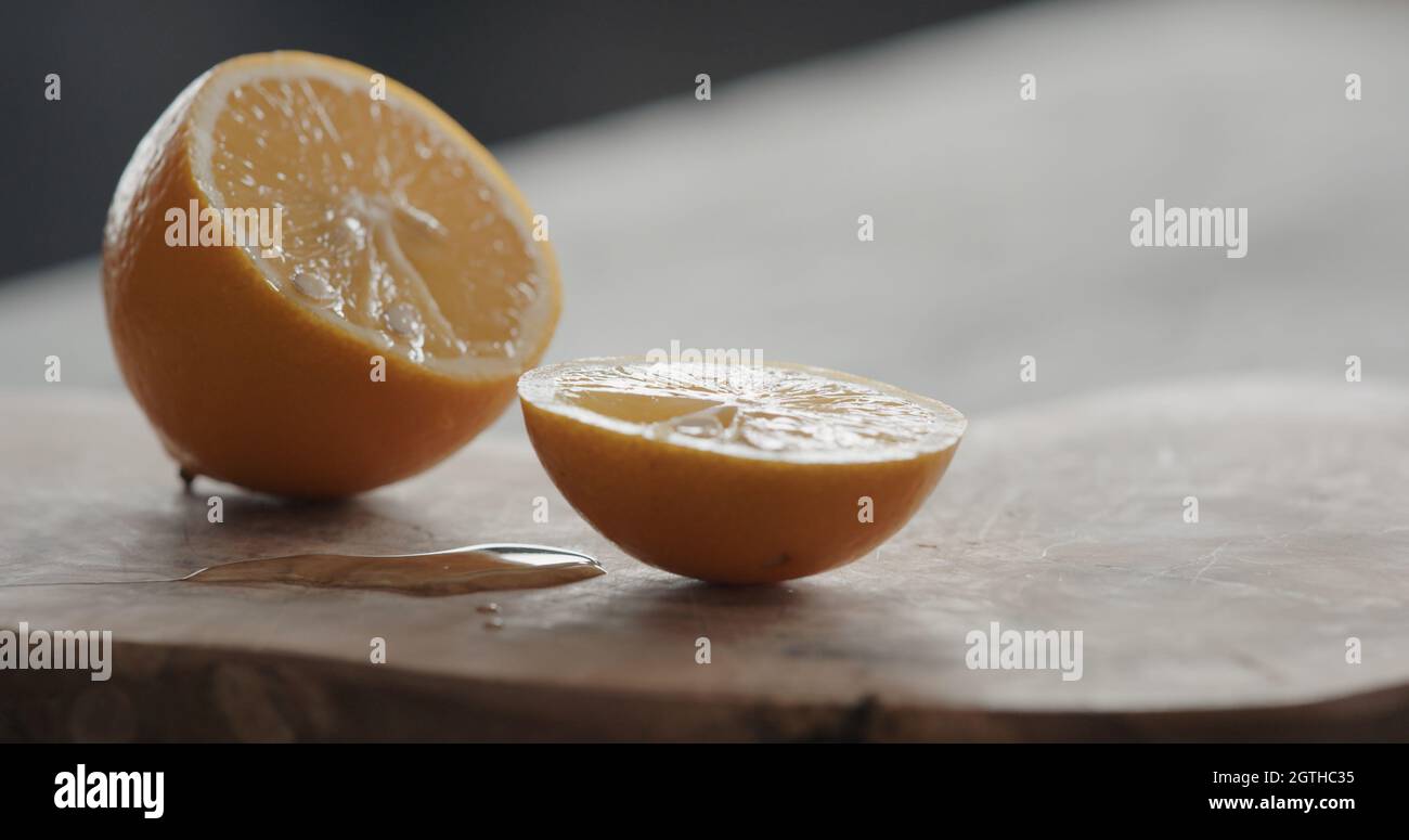 man cut sweet lemon on olive board, wide photo Stock Photo