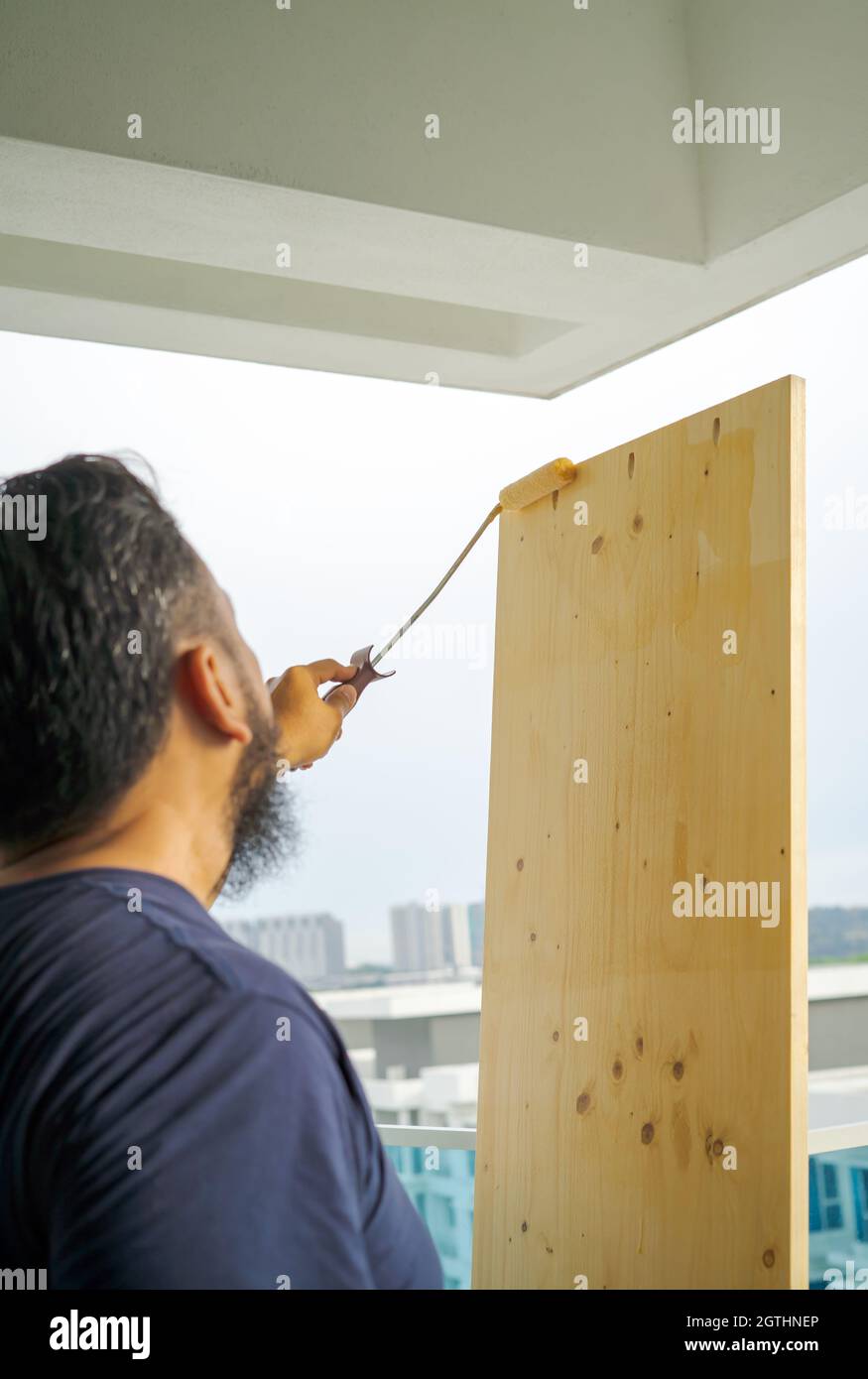Applying Clear Coat Paint On A Wooden Surface With Roller Brush. Painting  Wood Wall And Floor Stock Photo - Alamy