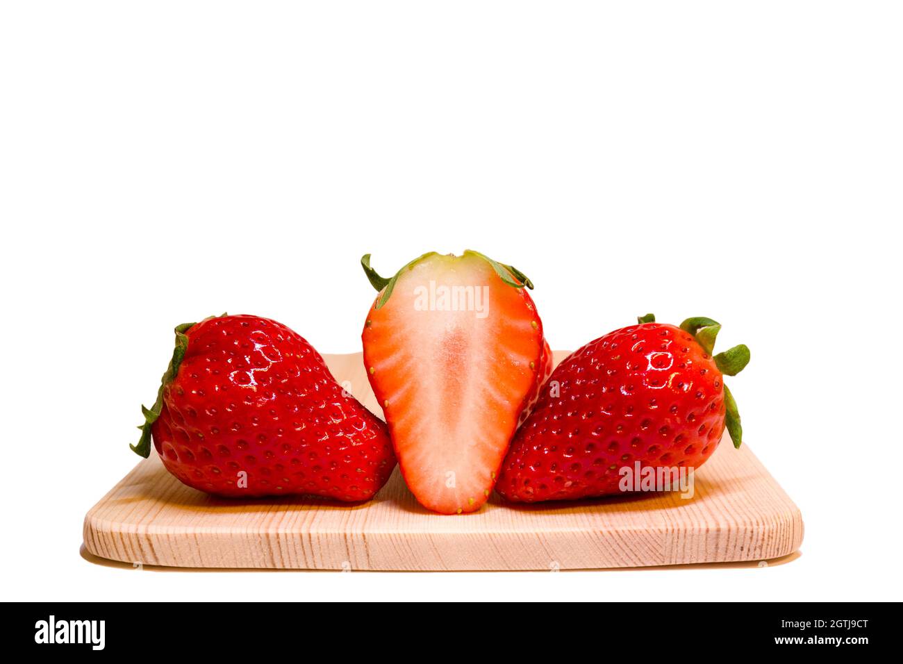 Close Up Of Strawberries Full And Half Size Placing Together On Wooden Plate With Clipping Path Stock Photo
