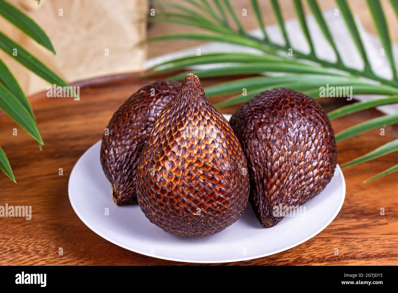 Fresh brown tropical salak fruit ripe on wooden background close up Stock Photo