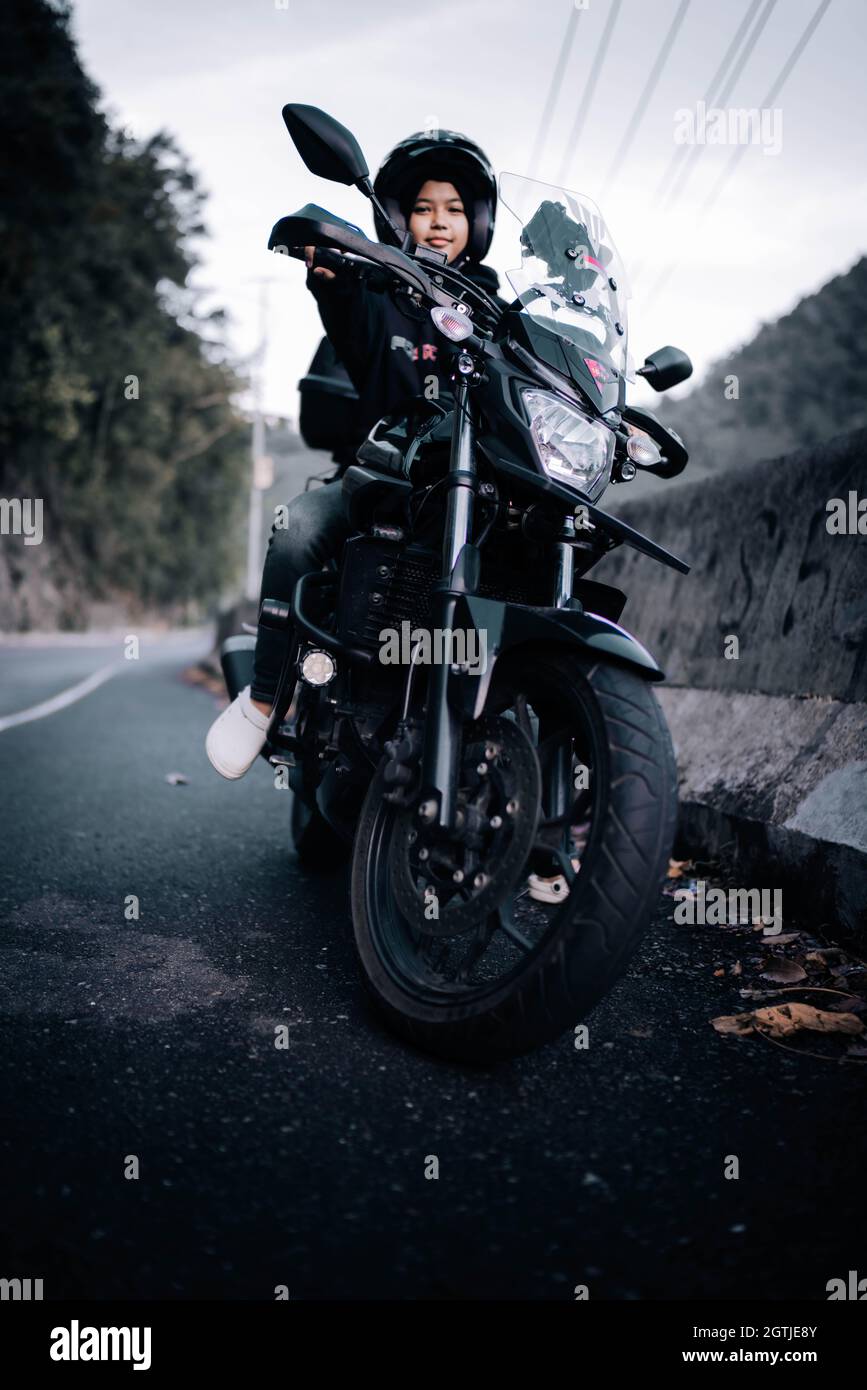 Portrait Of Girl Riding Motorcycle On Road Stock Photo Alamy