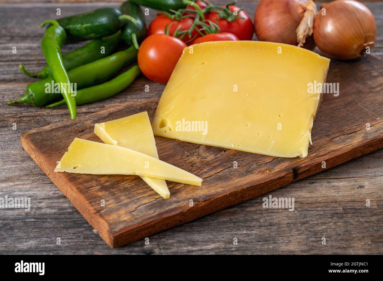 Gruyere cheese on wood background Stock Photo
