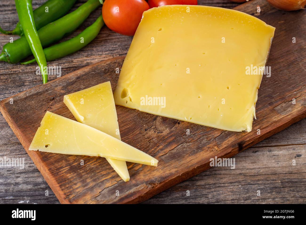 Gruyere cheese on wood background Stock Photo