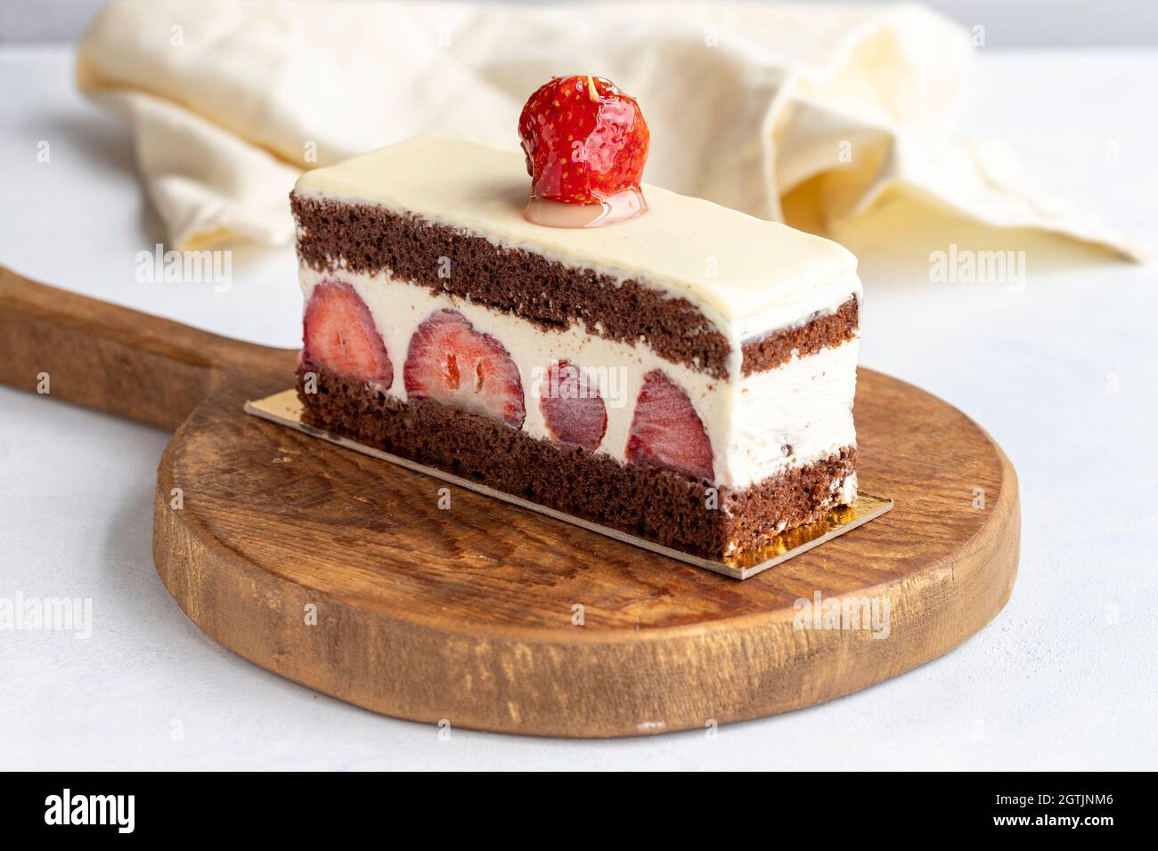 Slice of strawberry cake on a white background Stock Photo - Alamy