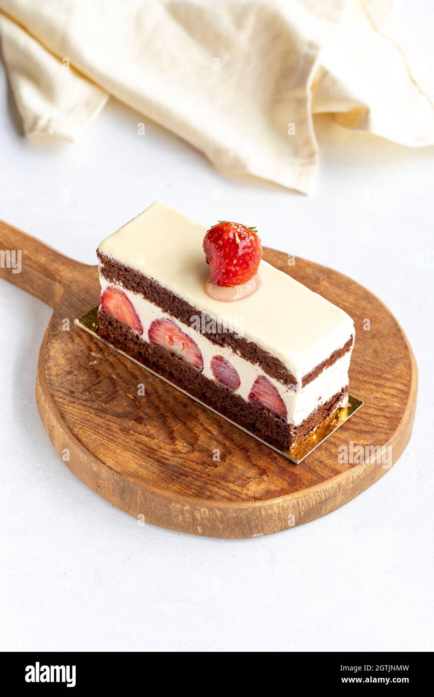 Slice of strawberry cake on a white background Stock Photo - Alamy