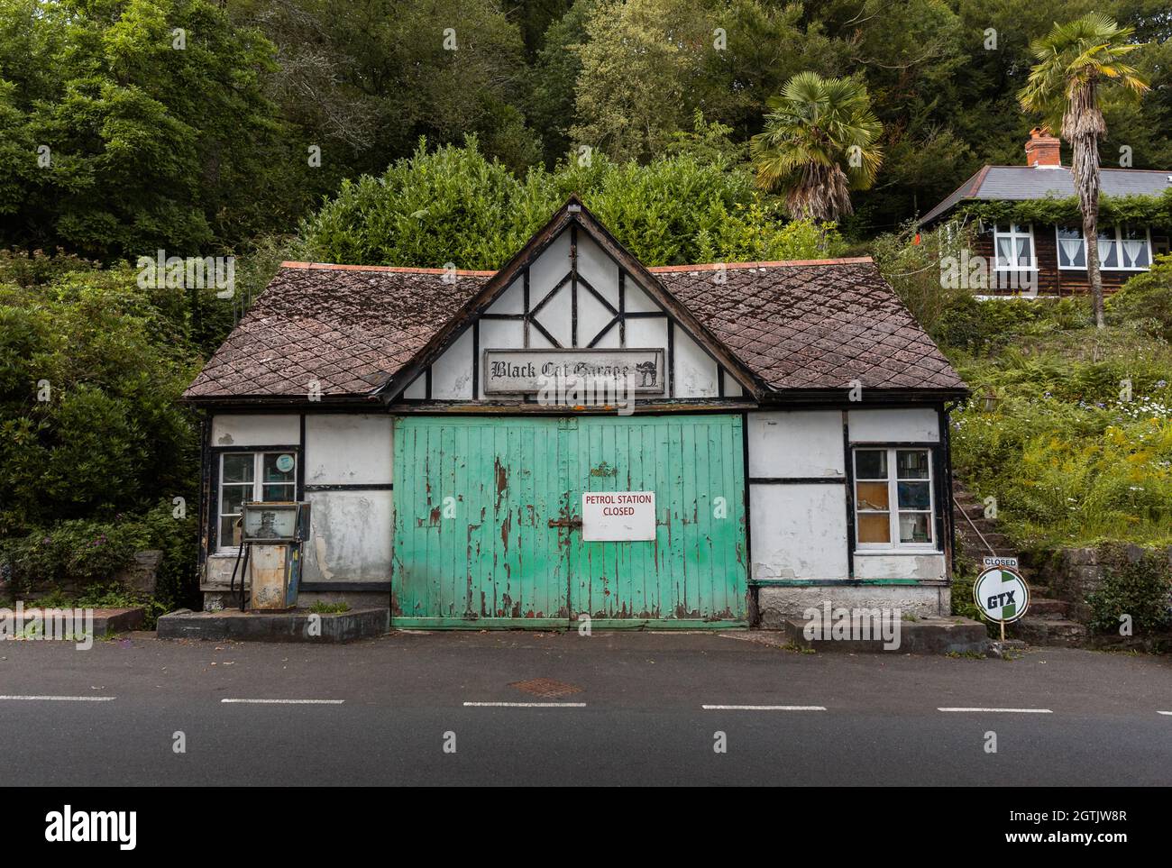 Closed Black Cat garage and petrol station on the A396, in Bampton, Devon Stock Photo