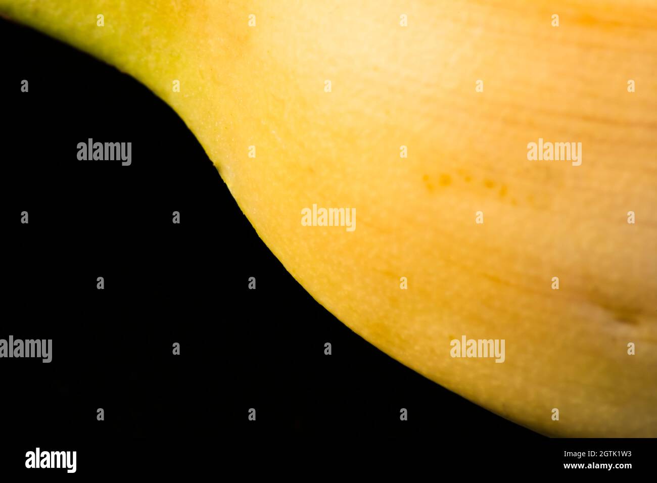 Macro Fruit: Ripe banana extreme close-up, horizontal format, black background Stock Photo