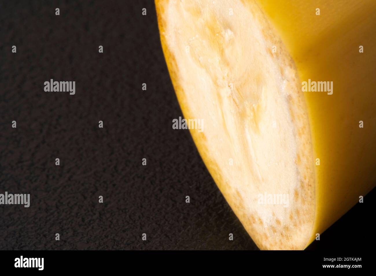 Macro Fruit: Ripe banana extreme close-up, horizontal format, black background Stock Photo