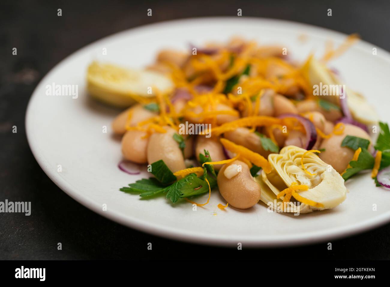 Great Northern Beans Salad with Artichoke and Orange dressing Stock Photo