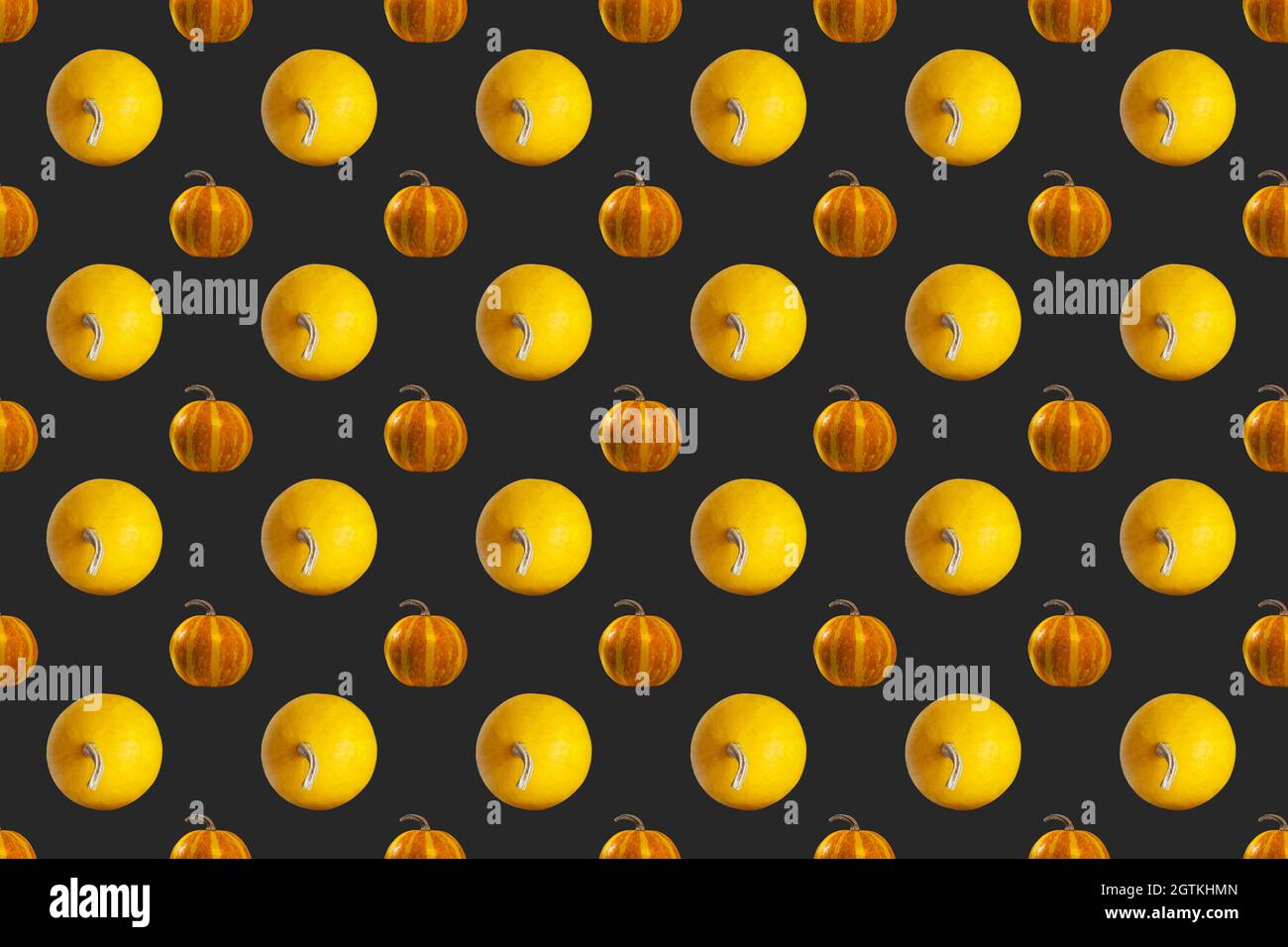 Pumpkins Seamless Pattern on Dark background, top view, Autumn Holiday Concept. Stock Photo