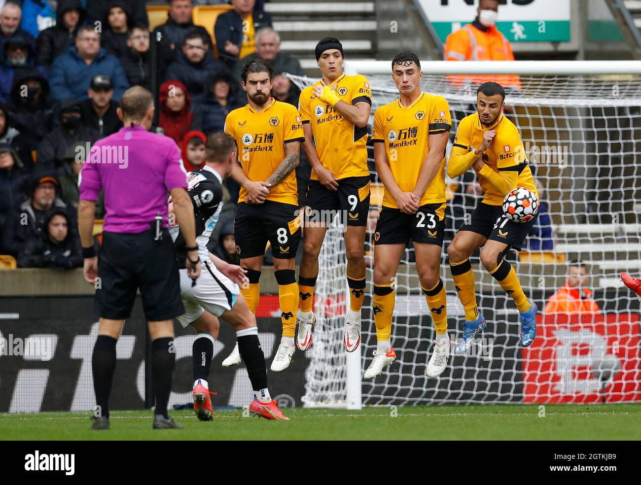 Wolverhampton, England, 2nd October 2021.  Wolves players jump to defend a free kick during the Premier League match at Molineux, Wolverhampton. Picture credit should read: Darren Staples / Sportimage Stock Photo