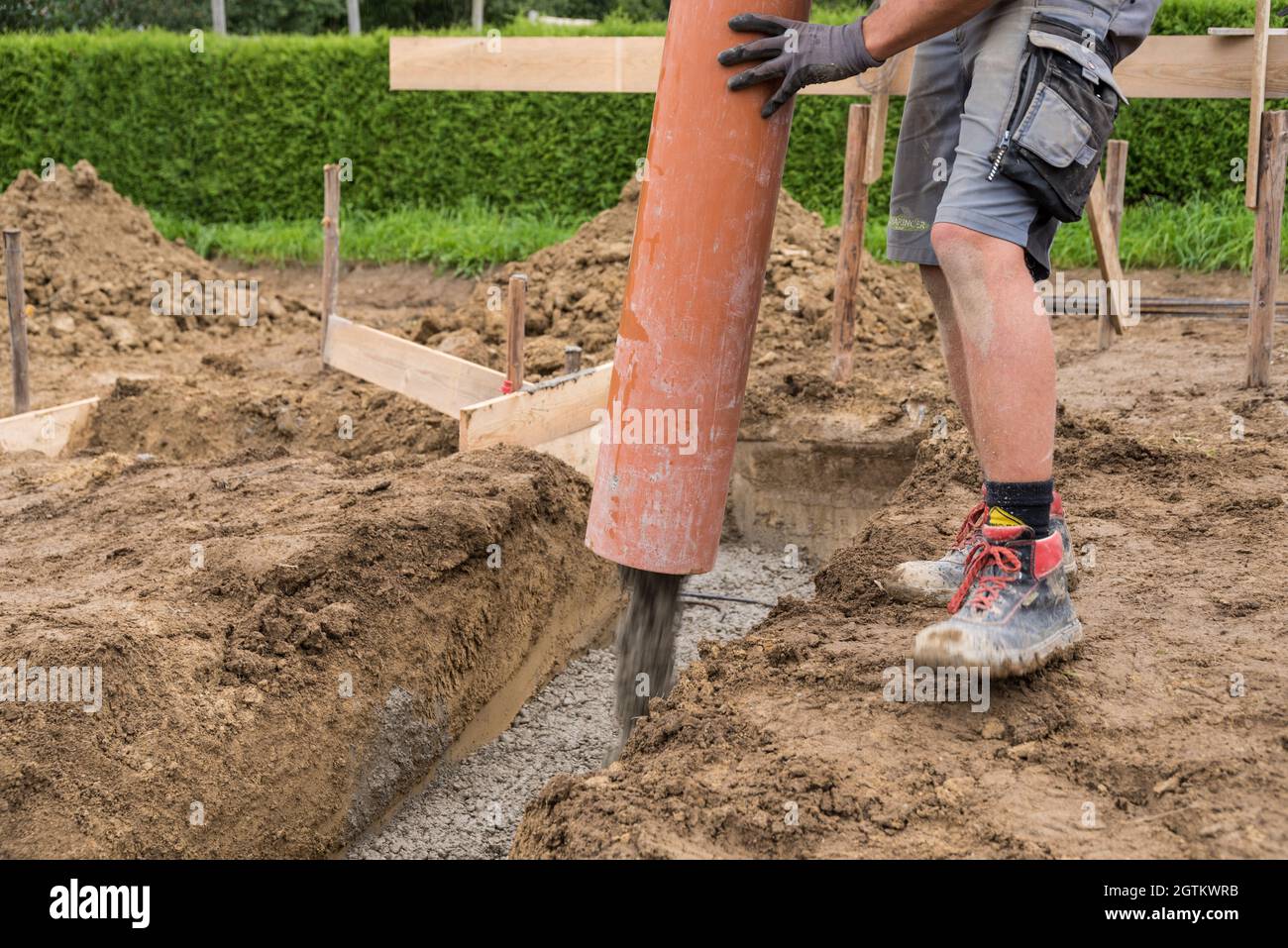 Construction Workers Pouring Concrete - Bricklayers And Concrete Workers Stock Photo