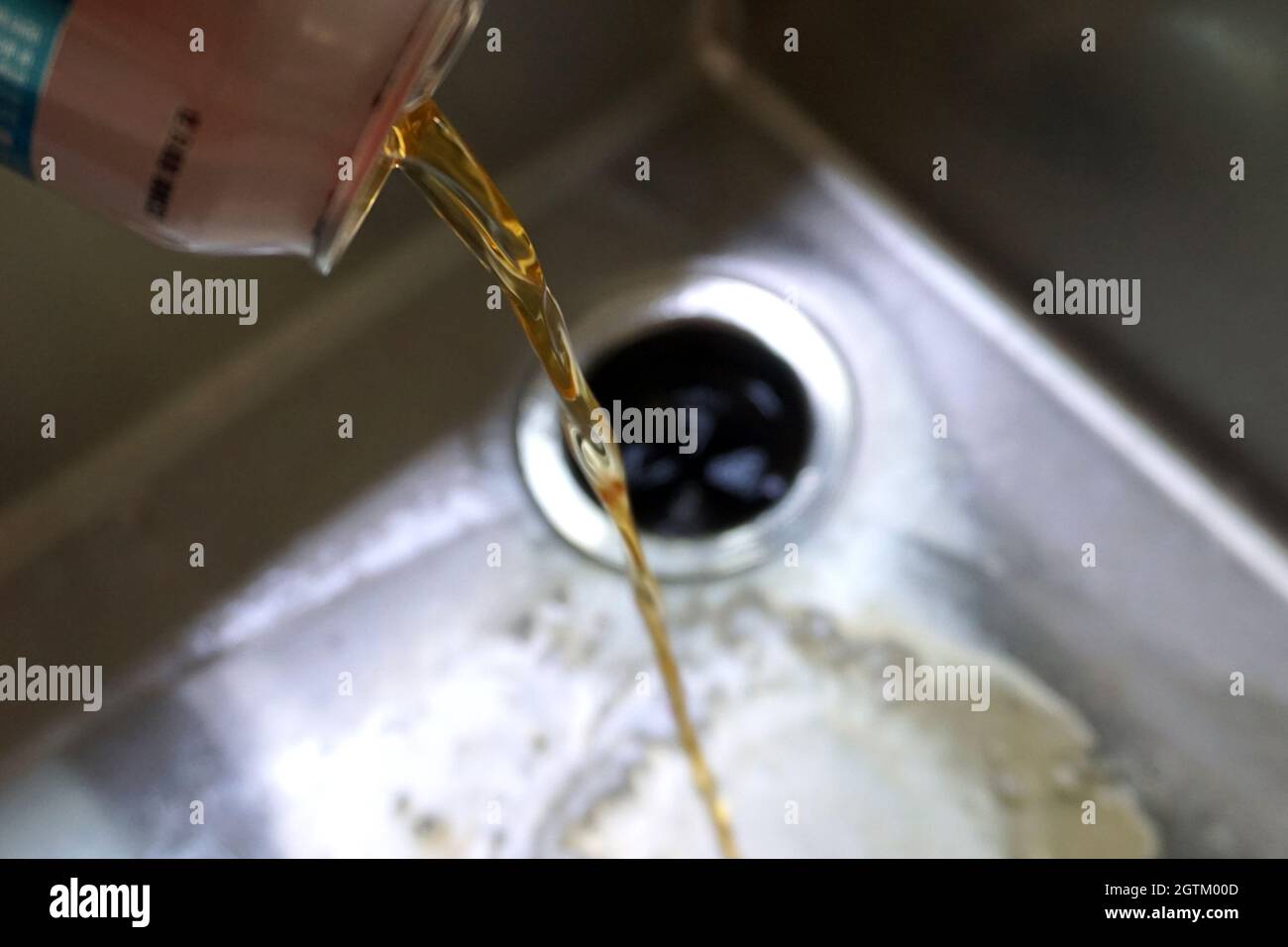 Pouring beer down the drain at the start of Sober October or Dry January, a month of abstinence from alcohol Stock Photo