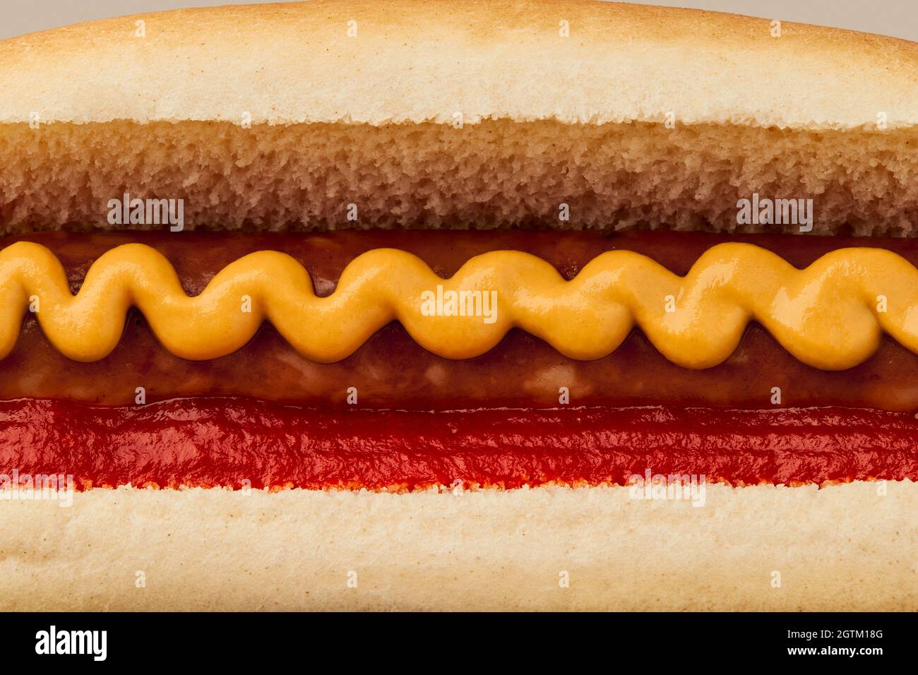 Classic hot dog with wurst, ketchup and mustard macro. Menu for