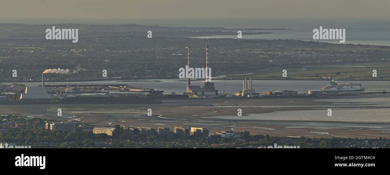 Dublin, Ireland - June 11, 2021: Beautiful aerial panorama of Poolbeg CCGT chimneys, Pigeon House Power Station and Irish Ferries seen from Ticknock. Stock Photo