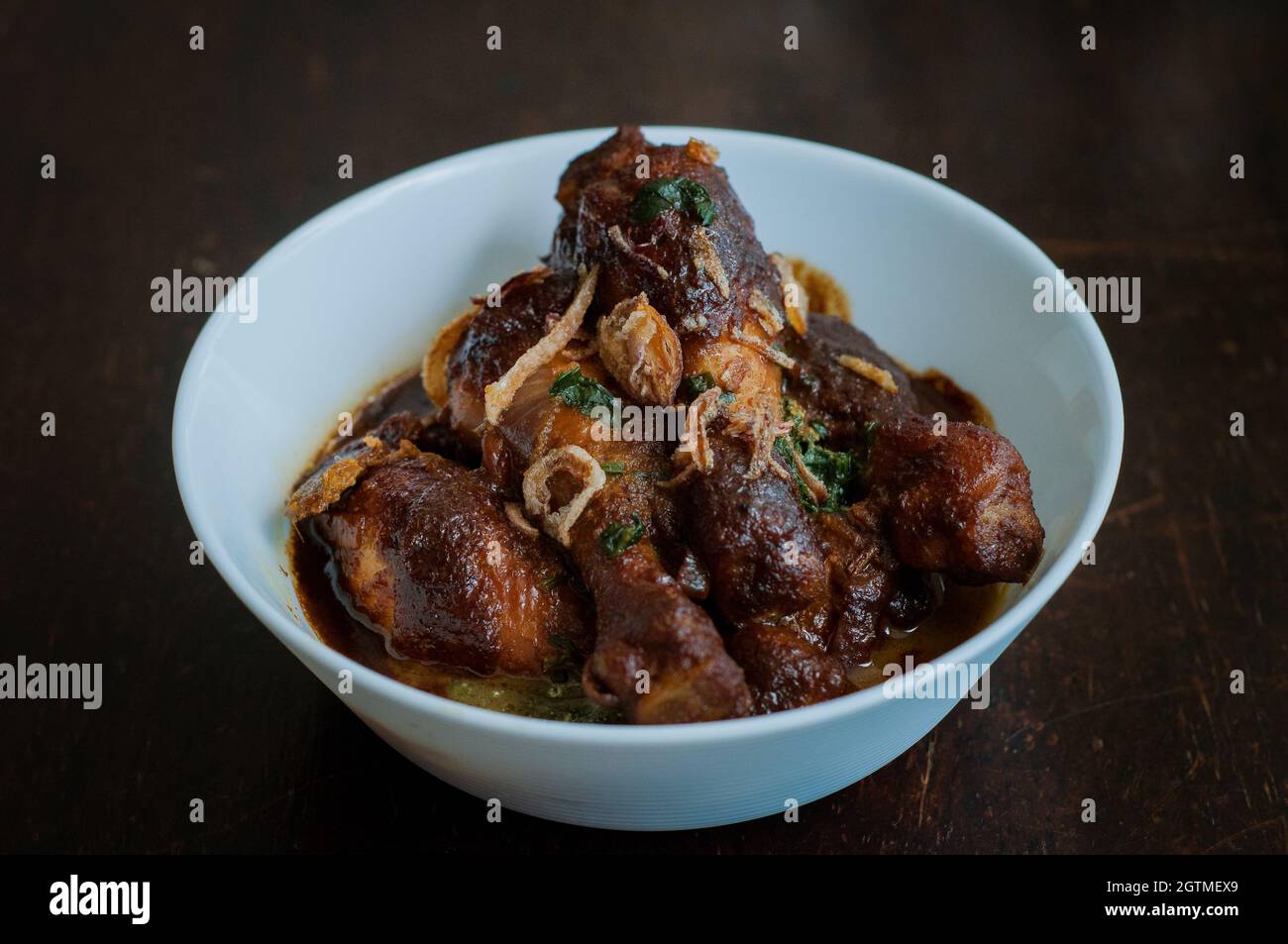 Malaysian Dish Of Ayam Masak Kicap Or Deep Fried Chicken In Black Soy Gravy In A White Bowl Stock Photo Alamy