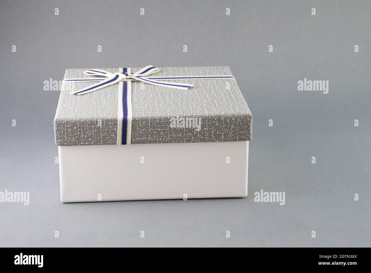 Close-up Of Gift Box Against Gray Background Stock Photo