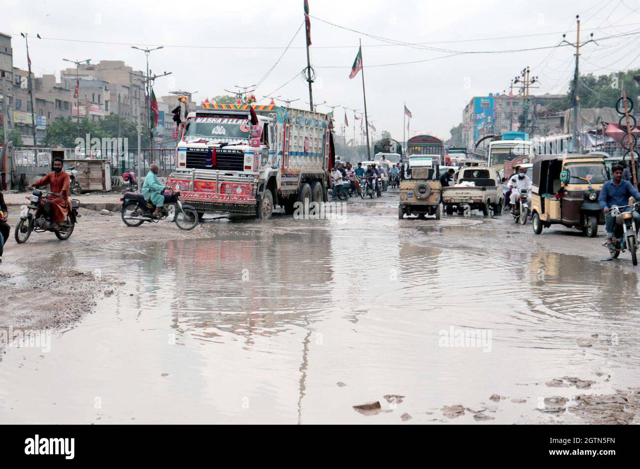 Commuters are facing difficulties in transportation due to stagnant sewerage water due to poor sewerage system and wreckage condition of road, creating problems for residents, showing negligence of concerned authorities, located on Liaquatabad area of Karachi on Saturday, October 02, 2021. Stock Photo