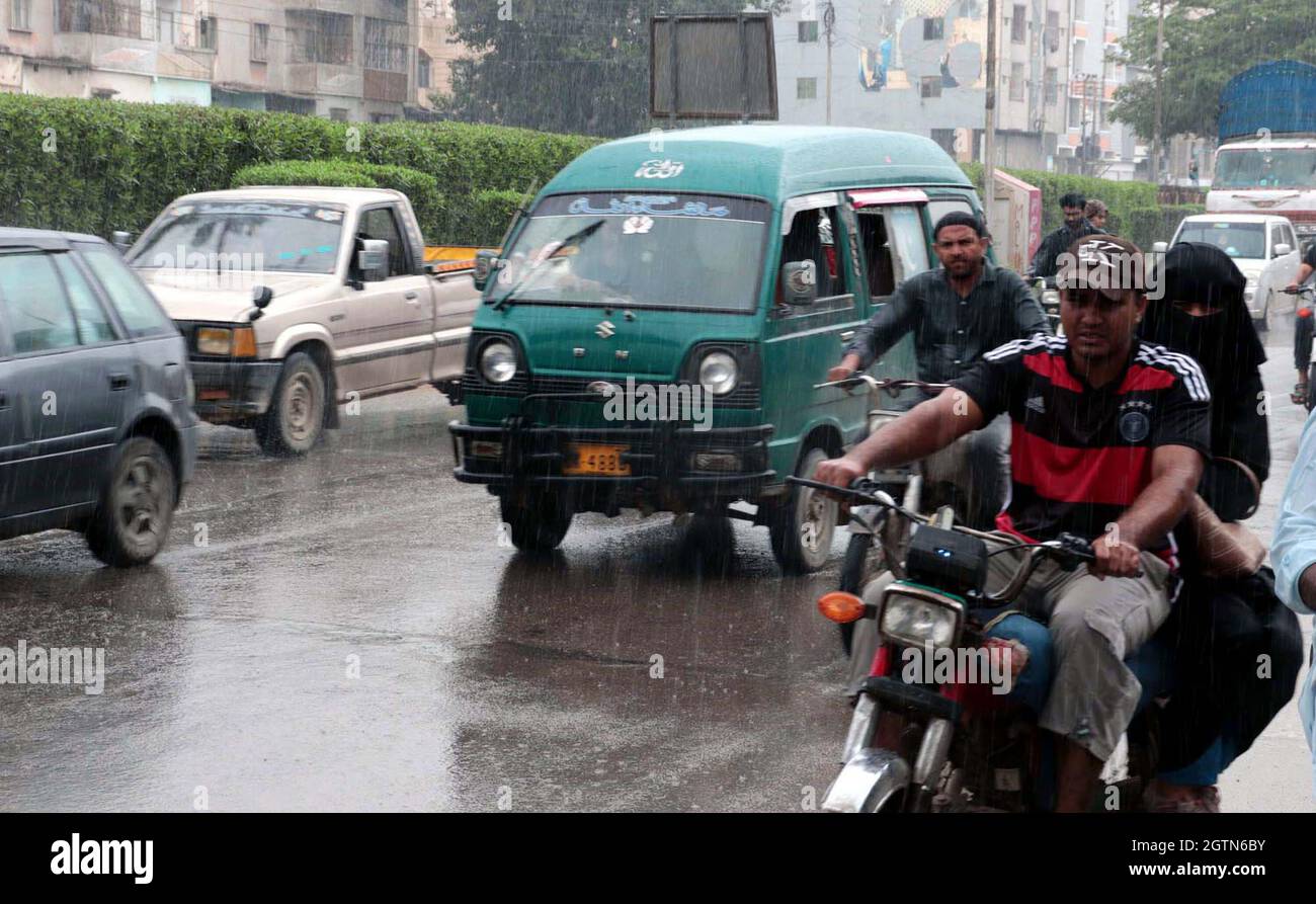 Commuters are passing through road during heavy downpour of monsoon season located on Liaquatabad area of Karachi on Saturday, October 02, 2021. Stock Photo