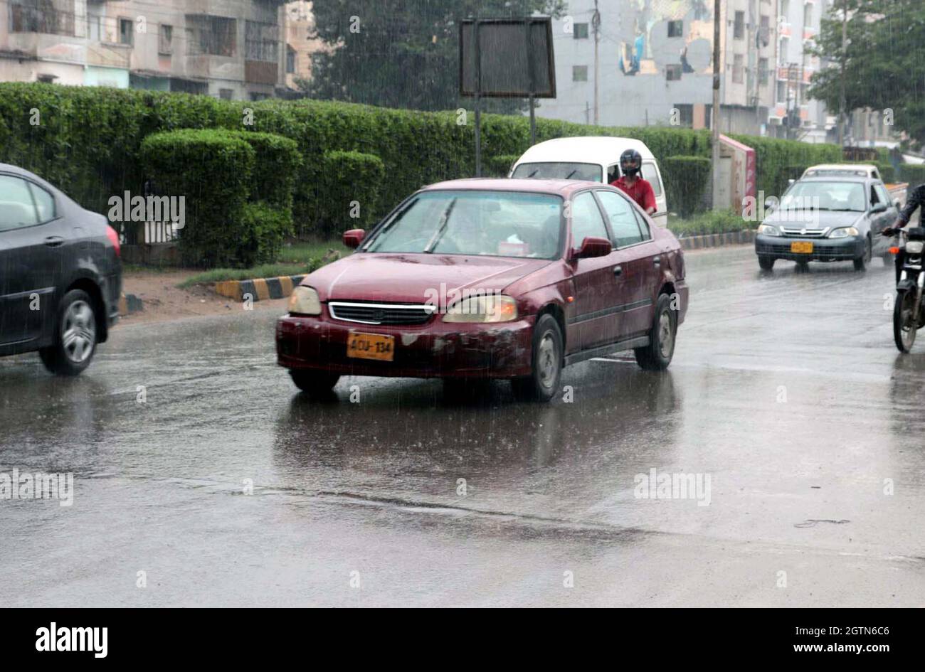 Commuters are passing through road during heavy downpour of monsoon season located on Liaquatabad area of Karachi on Saturday, October 02, 2021. Stock Photo