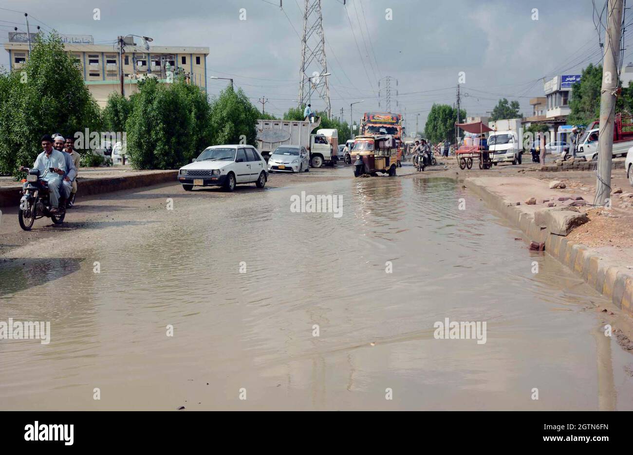 KARACHI, PAKISTAN, OCT 02: Inundated road by stagnant sewerage and rainwater water after downpour of monsoon season due to poor sewerage system, causing unhygienic atmosphere and creating problems commuters, showing negligence of concerned authorities, located on Korangi Industrial area of Karachi on Saturday, October 02, 2021. Stock Photo