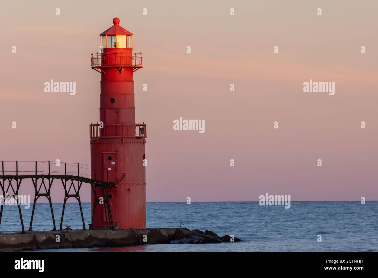 A Red Breakwater Lighthouse On Lake Michigan Stock Photo