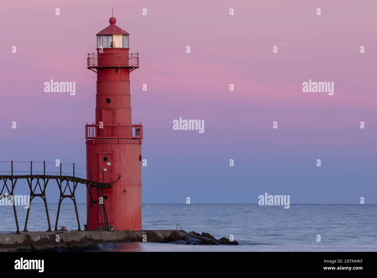 A Red Breakwater Lighthouse On Lake Michigan Stock Photo