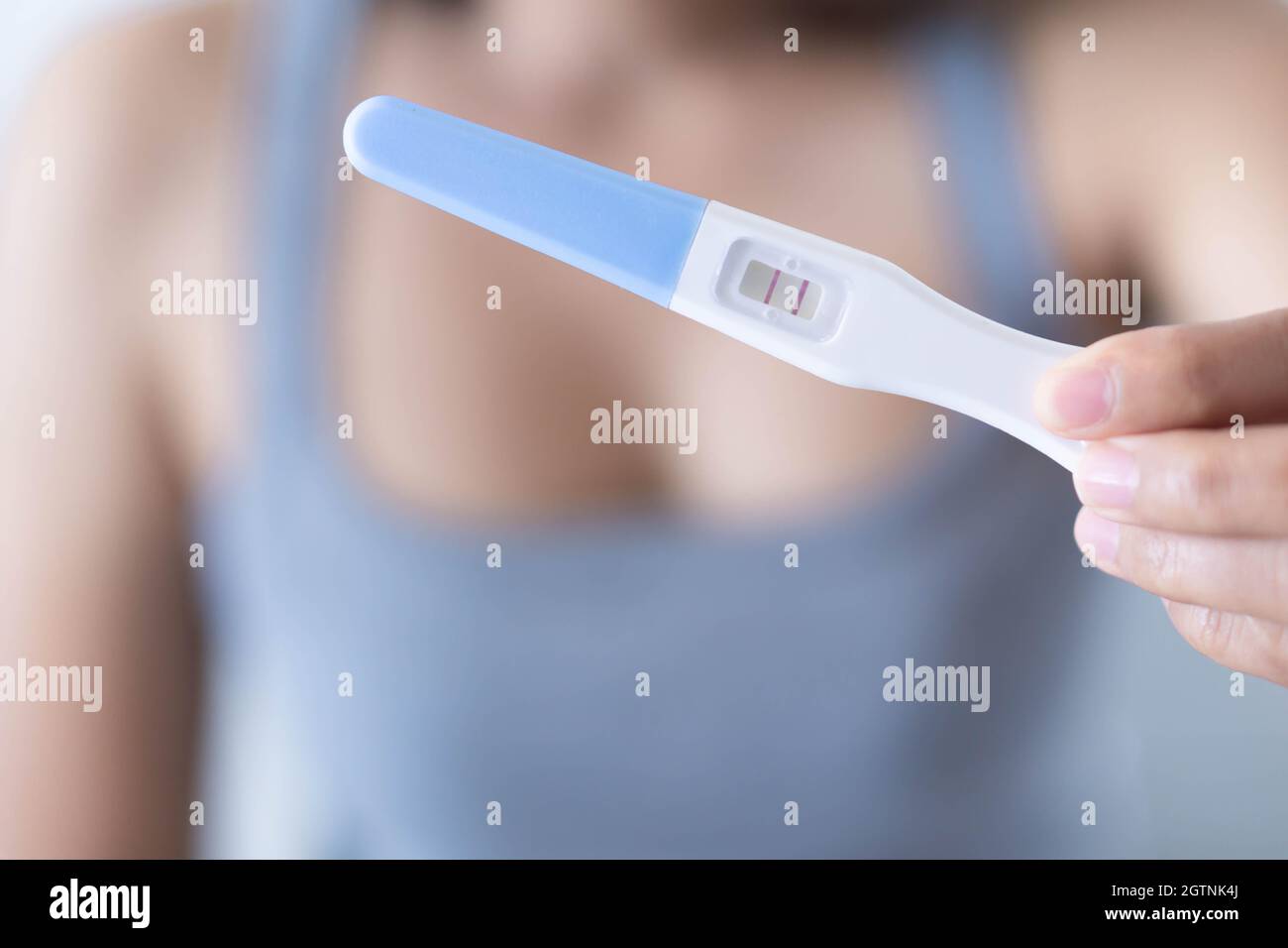 Close-up Of Woman Holding Pregnancy Test Stock Photo