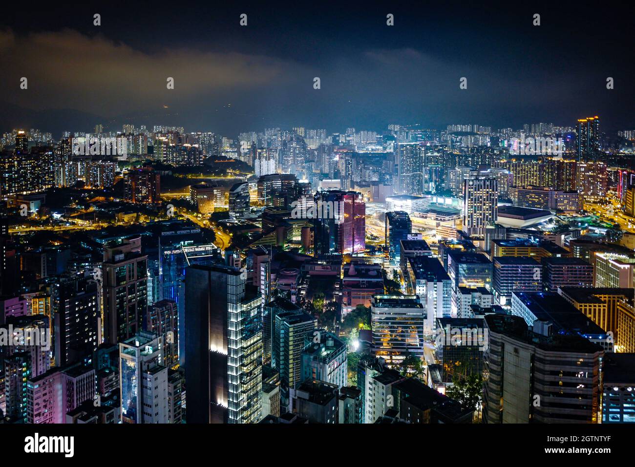 High Angle View Of Illuminated City Buildings At Night Stock Photo