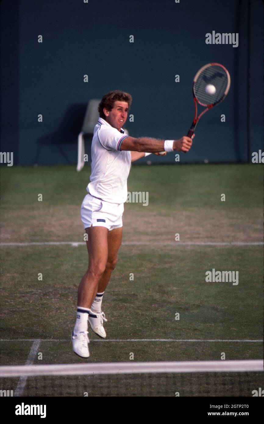 Brian Gottfried hitting a backhand volley during a match at Wimbledon in 1984 Stock Photo