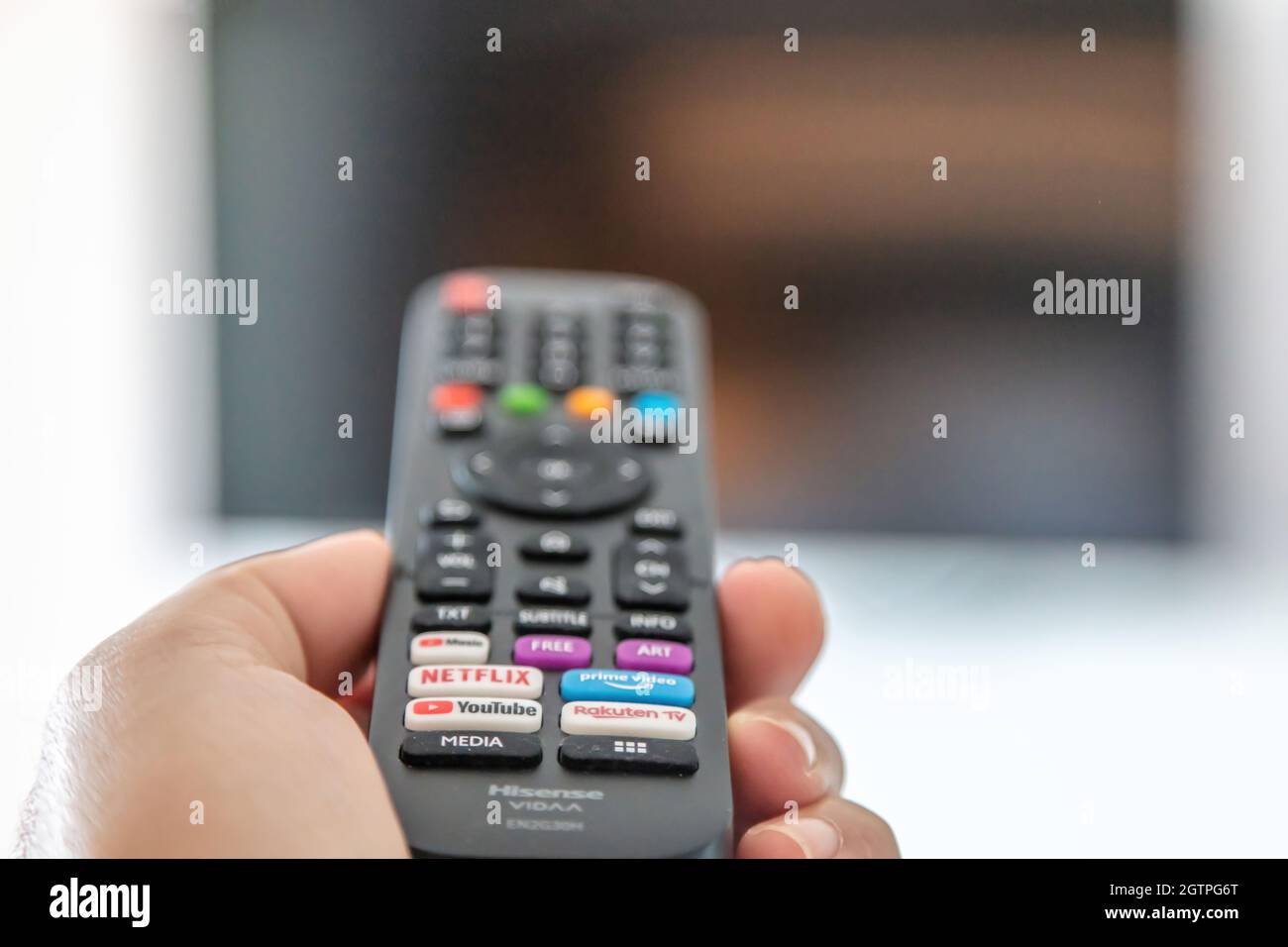 Greece Stoupa. September 27 2021. TV remote control in male hand, Watching television and channel switching concept. Stock Photo