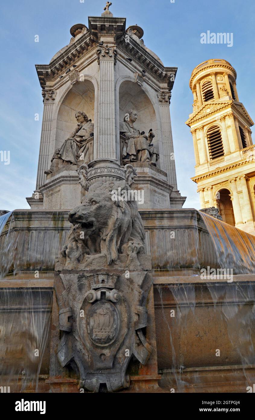 The Fontaine Saint-Sulpice, also known as the Fountain of the Four Bishops, stands before the landmark Église Saint-Sulpice in Paris. Stock Photo