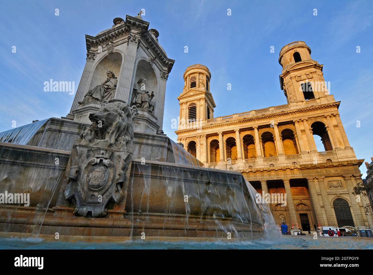 The Fontaine Saint-Sulpice, also known as the Fountain of the Four Bishops, stands before the landmark Église Saint-Sulpice church in Paris. Stock Photo
