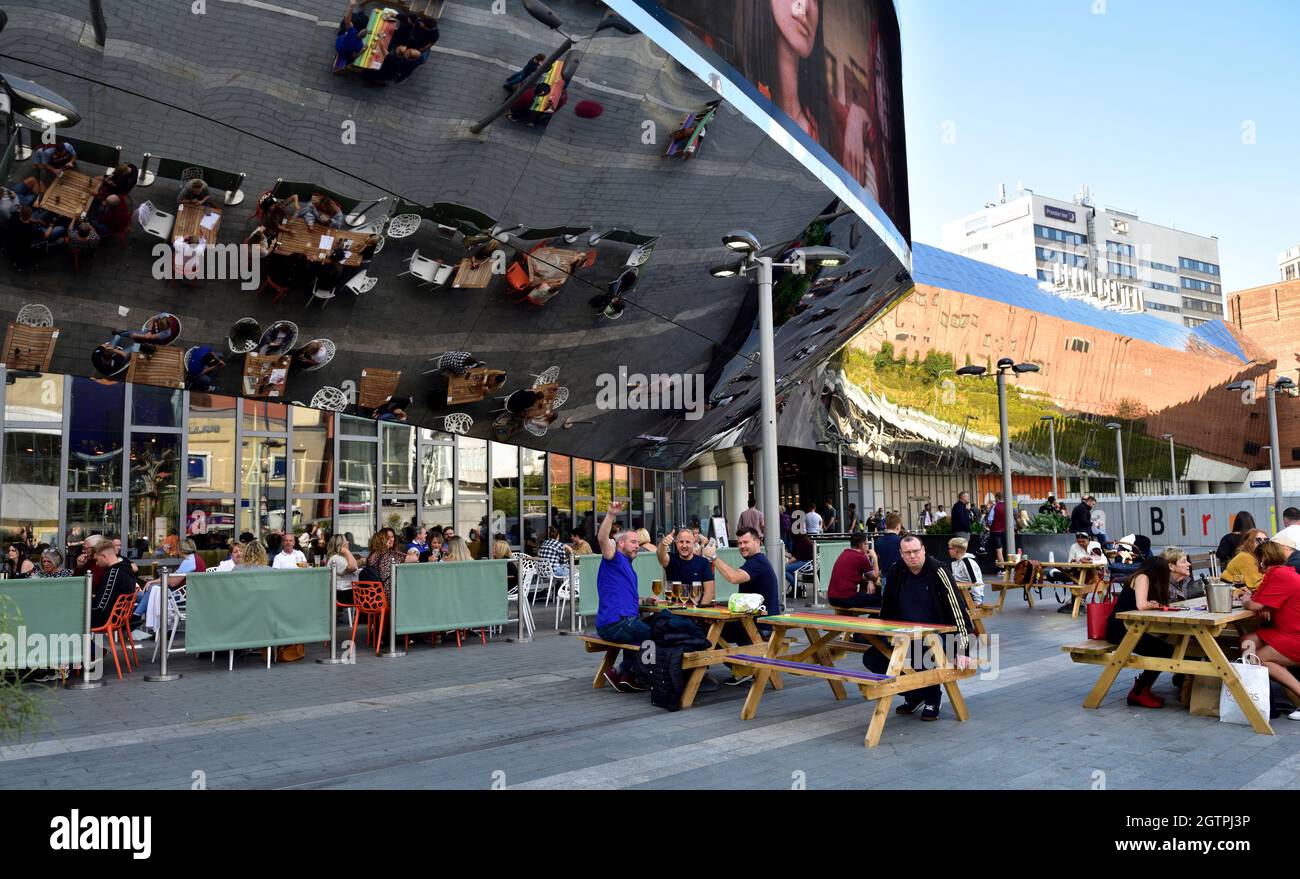 Birmingham New Street station with reflected image of dinners at cafe on “1000 Trades Square”, UK Stock Photo