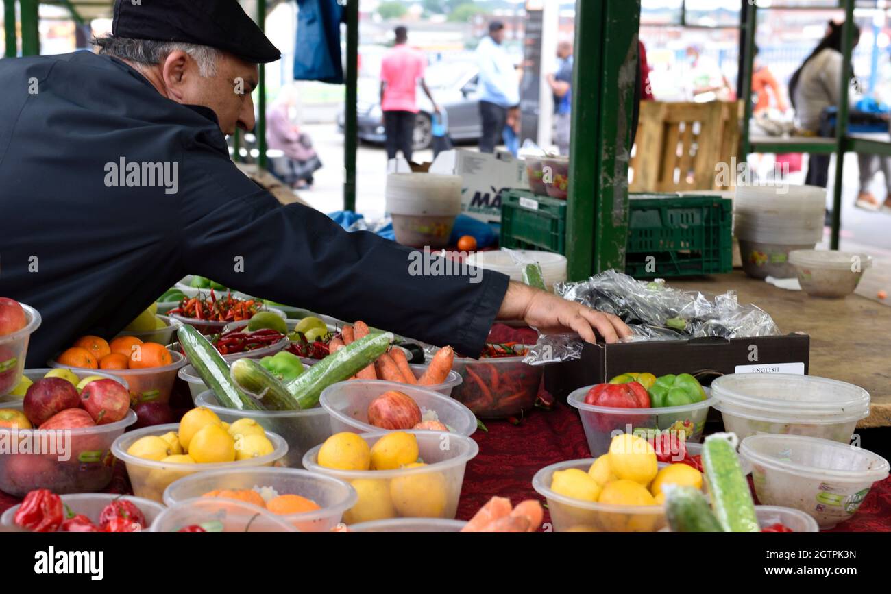 Shopper looking for fruit and vegetables at Birmingham Bullring Open Market Stock Photo