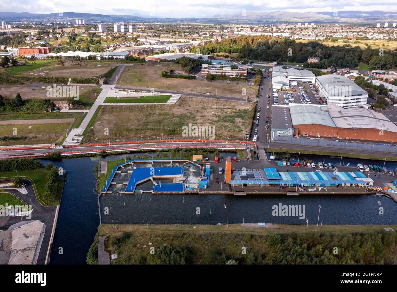 Glasgow, Scotland, UK. 29 September 2021 PICTURED: Pinkston Watersports centre white water rapids facility for rafting, canoeing and kayaking. Aerial drone view of Glasgow’s Sighthill area showing the new bridge over the M8 Motorway which joins the north of the city centre form the East going through to Charing Cross. The Sighthill area is seeing a capital investment of £250million with new recreational areas and social housing to the north of the city. Also in the area are white water rafting and kayaking training centres along with wakeboarding training facilities. Credit: Colin Fisher Stock Photo