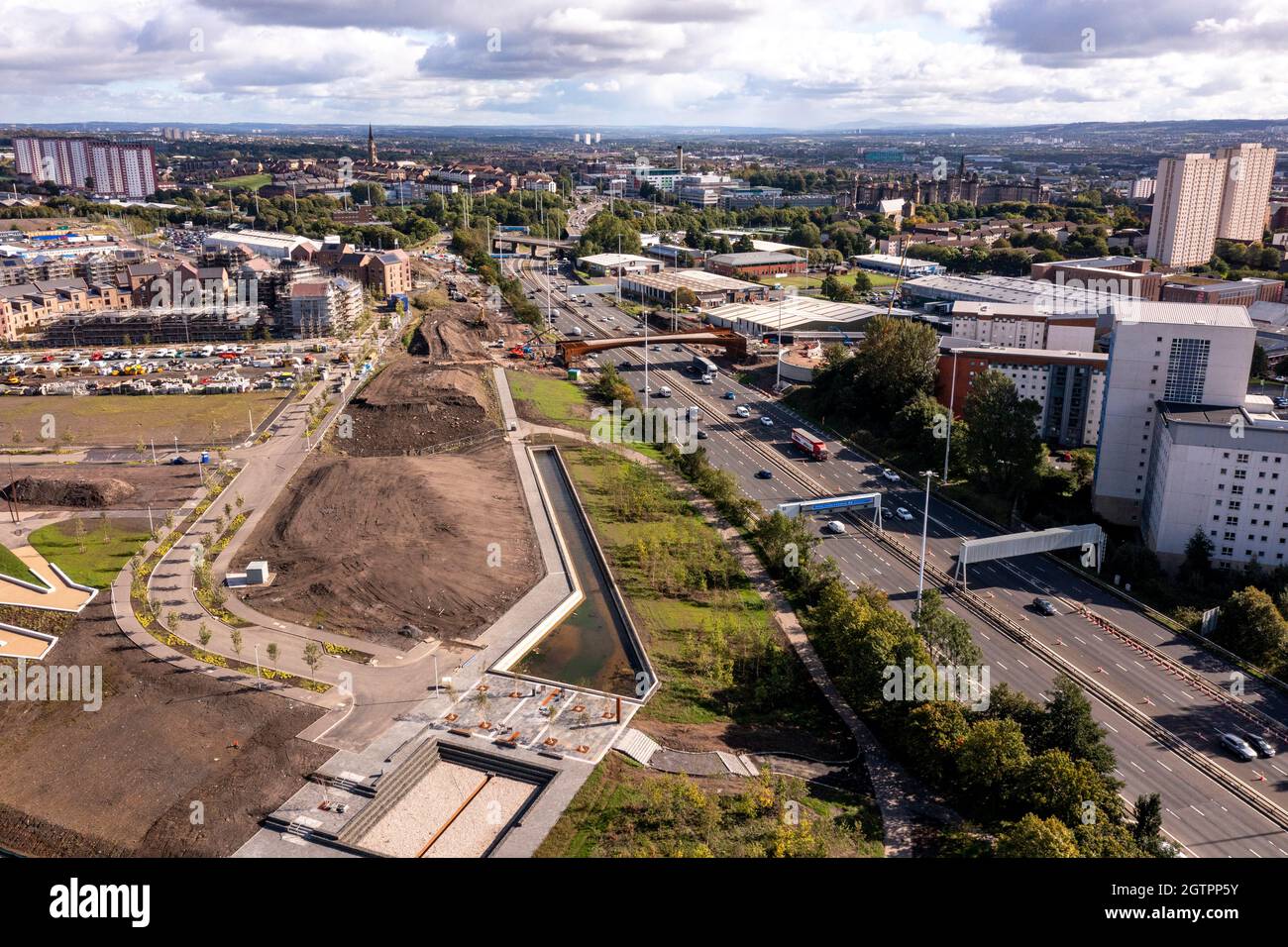 Glasgow, Scotland, UK. 29 September 2021 PICTURED:  New bridge at Sighhill over the M8 motorway. Aerial drone view of Glasgow’s Sighthill area showing the new bridge over the M8 Motorway which joins the north of the city centre form the East going through to Charing Cross. The Sighthill area is seeing a capital investment of £250million with new recreational areas and social housing to the north of the city. Also in the area are white water rafting and kayaking training centres along with wakeboarding training facilities. Credit: Colin Fisher Stock Photo