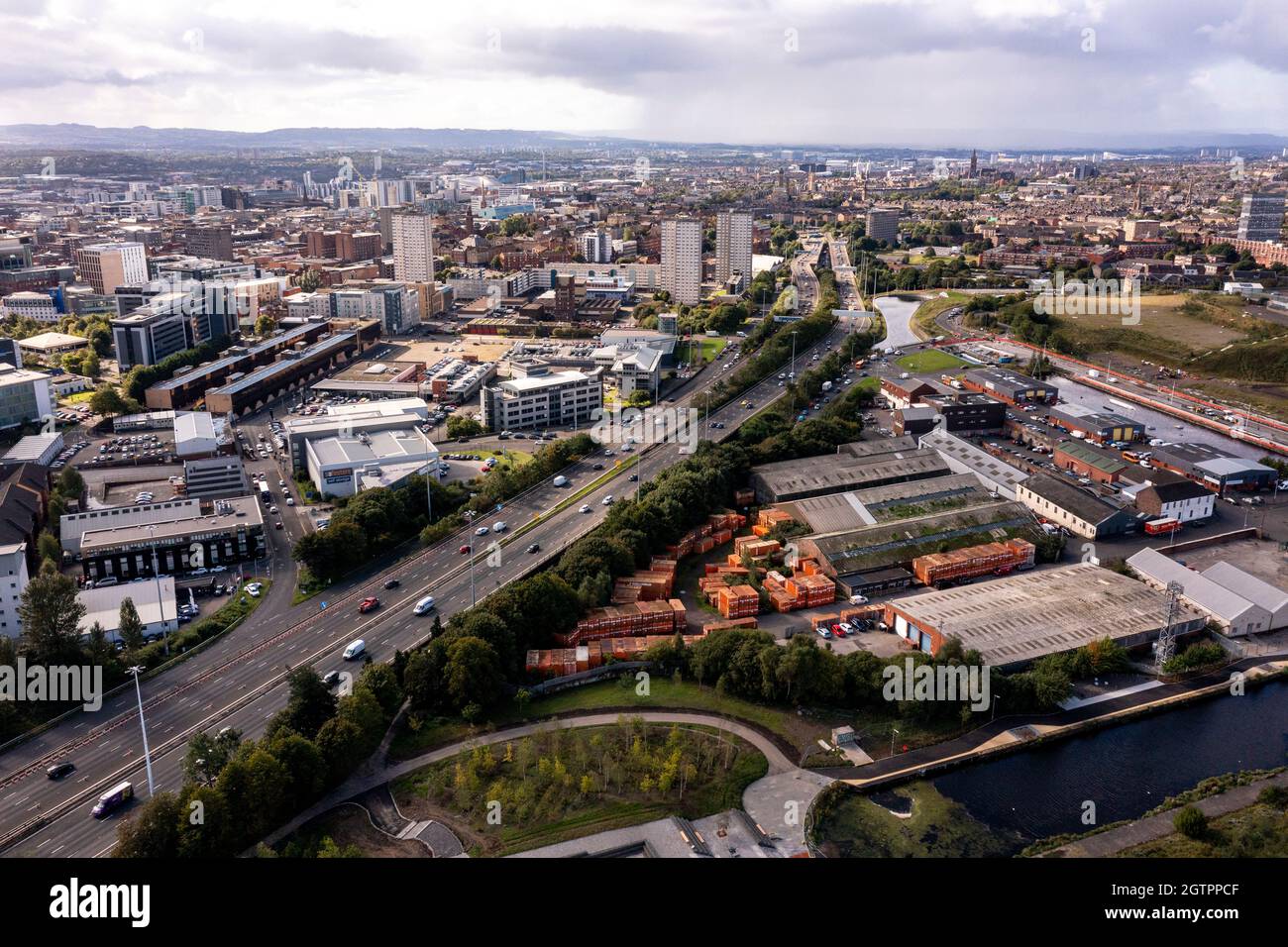 Glasgow, Scotland, UK. 29 September 2021 PICTURED:  Aerial drone view of Glasgow’s Sighthill area showing the new bridge over the M8 Motorway which joins the north of the city centre form the East going through to Charing Cross. The Sighthill area is seeing a capital investment of £250million with new recreational areas and social housing to the north of the city. Also in the area are white water rafting and kayaking training centres along with wakeboarding training facilities. Credit: Colin Fisher Stock Photo