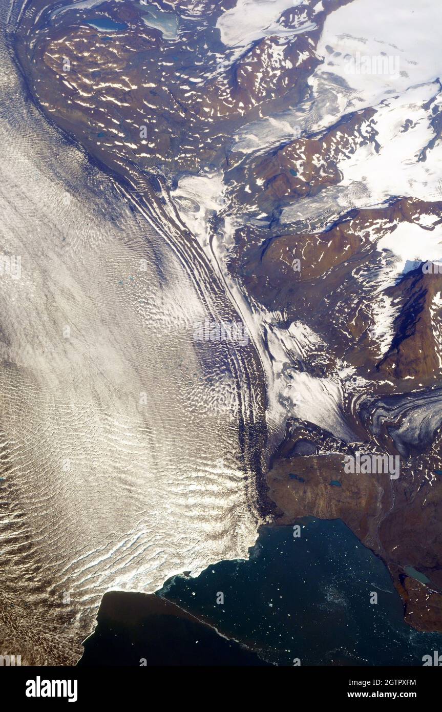 Glaciers from the Greenland ice cap calve into the sea on the east coast Stock Photo