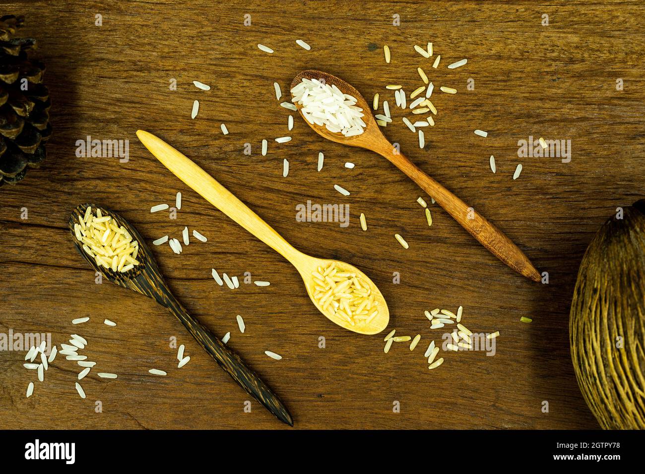 High Angle View Of Multigrain Rics And Wooden Spoin On Wooden Table Stock Photo
